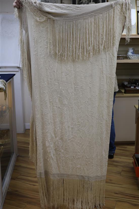 A Chinese embroidered shawl and another pale blue on cream embroidered shawl